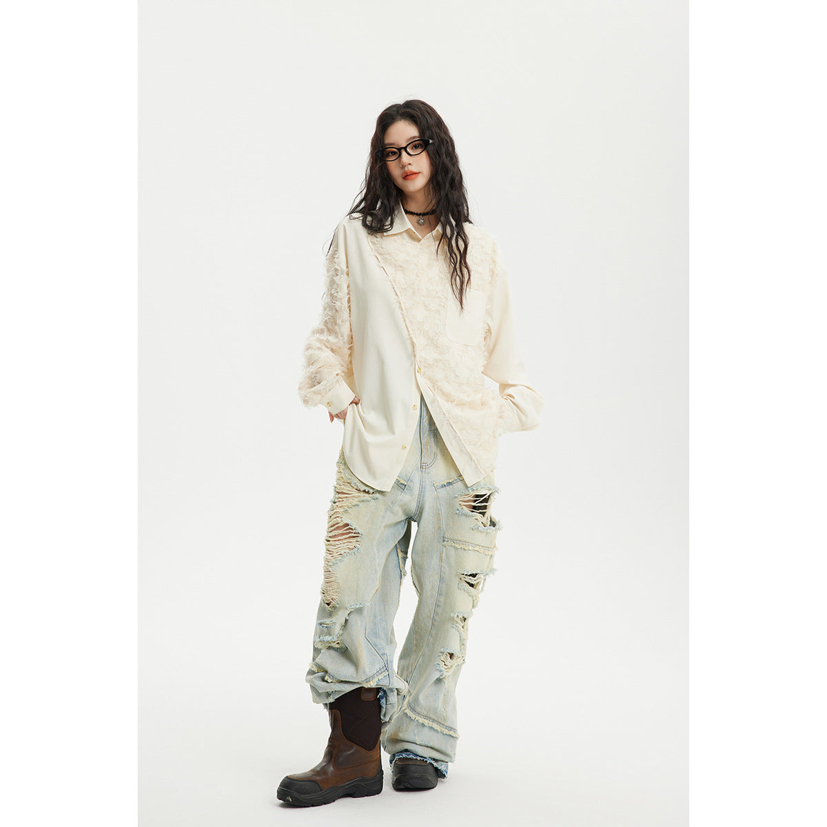 Model wearing an ivory collared button-up shirt with fluffy textured panels and oversized light-wash distressed jeans.