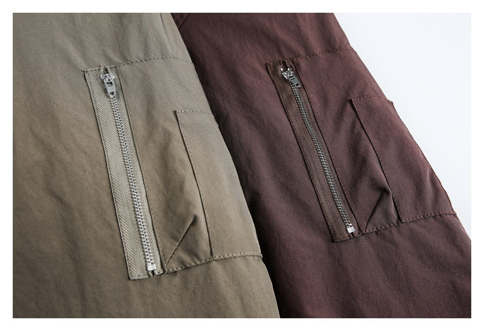 Close-up of sleeve zipper pockets on gray-brown and plum jackets.
