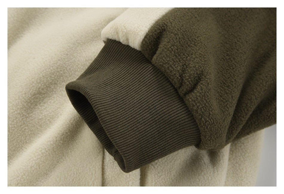 Close-up of a dark olive ribbed sleeve cuff with contrasting cream and olive fleece.