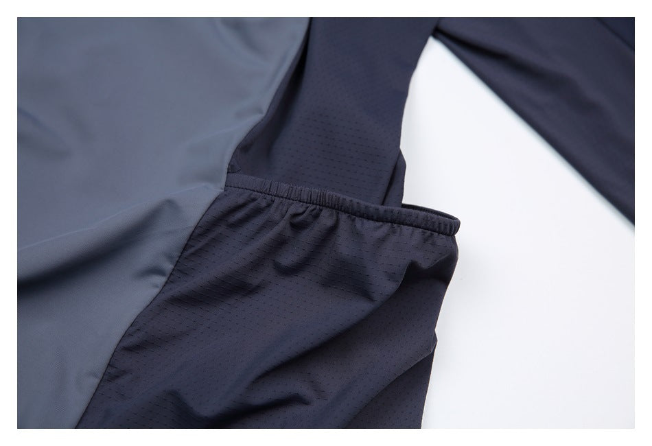 Close-up of the top's dark perforated side panel and sleeve seam.