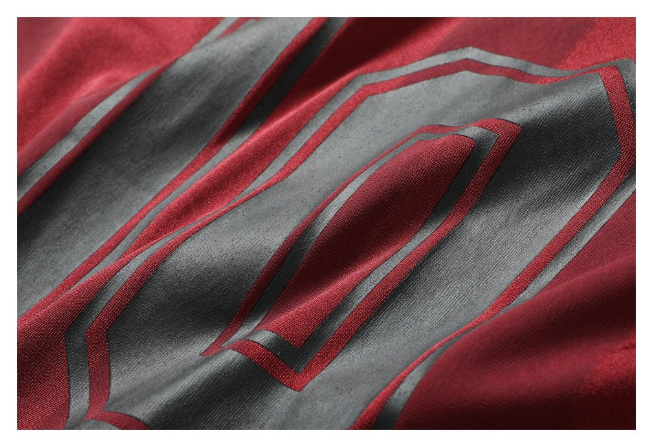 Close-up of the raised black, gray, and burgundy number graphic on the striped jersey.