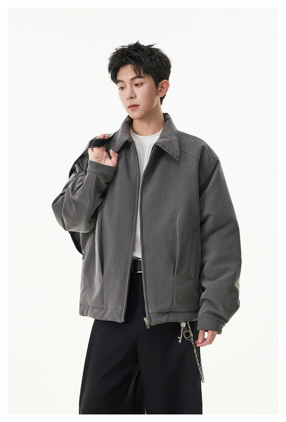Model wearing an open gray zip-front jacket with a pointed collar, roomy sleeves and side pockets.
