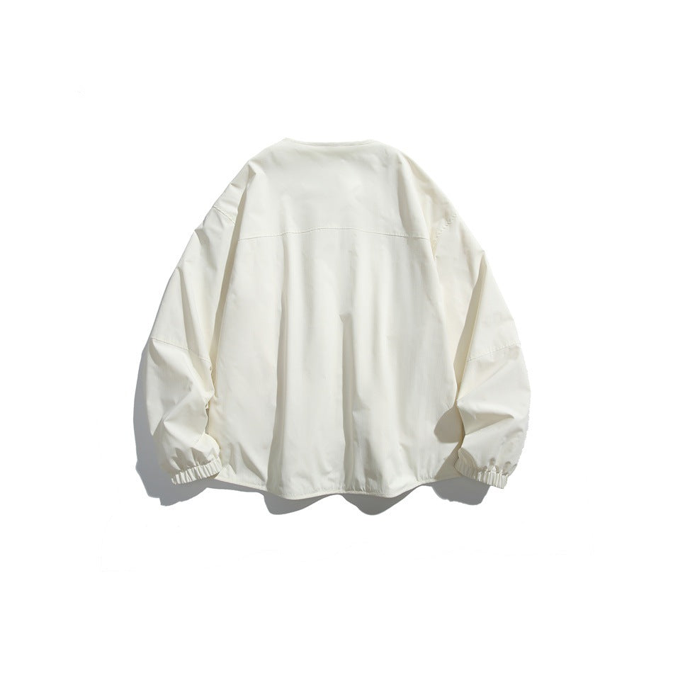 Back view of an ivory jacket with a yoke seam and gathered elastic cuffs.