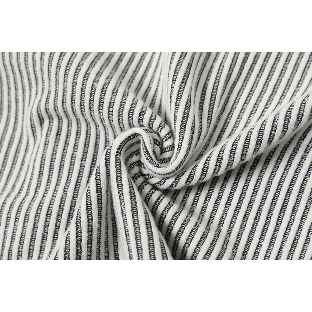 Close-up of white fabric with narrow black stripes, gathered to show its textured surface.