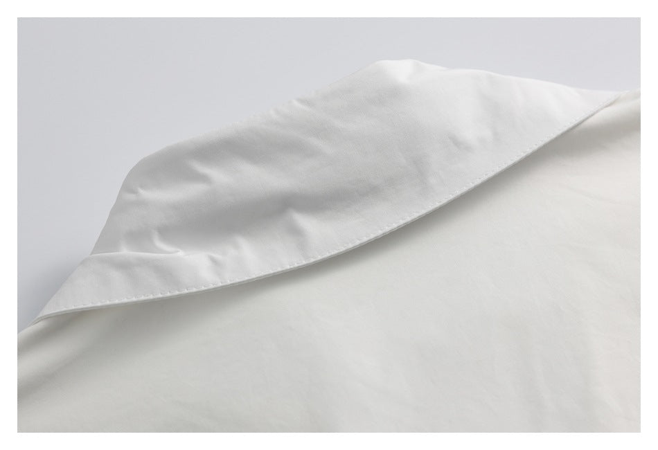 Close-up of a white garment collar with a neatly stitched edge.