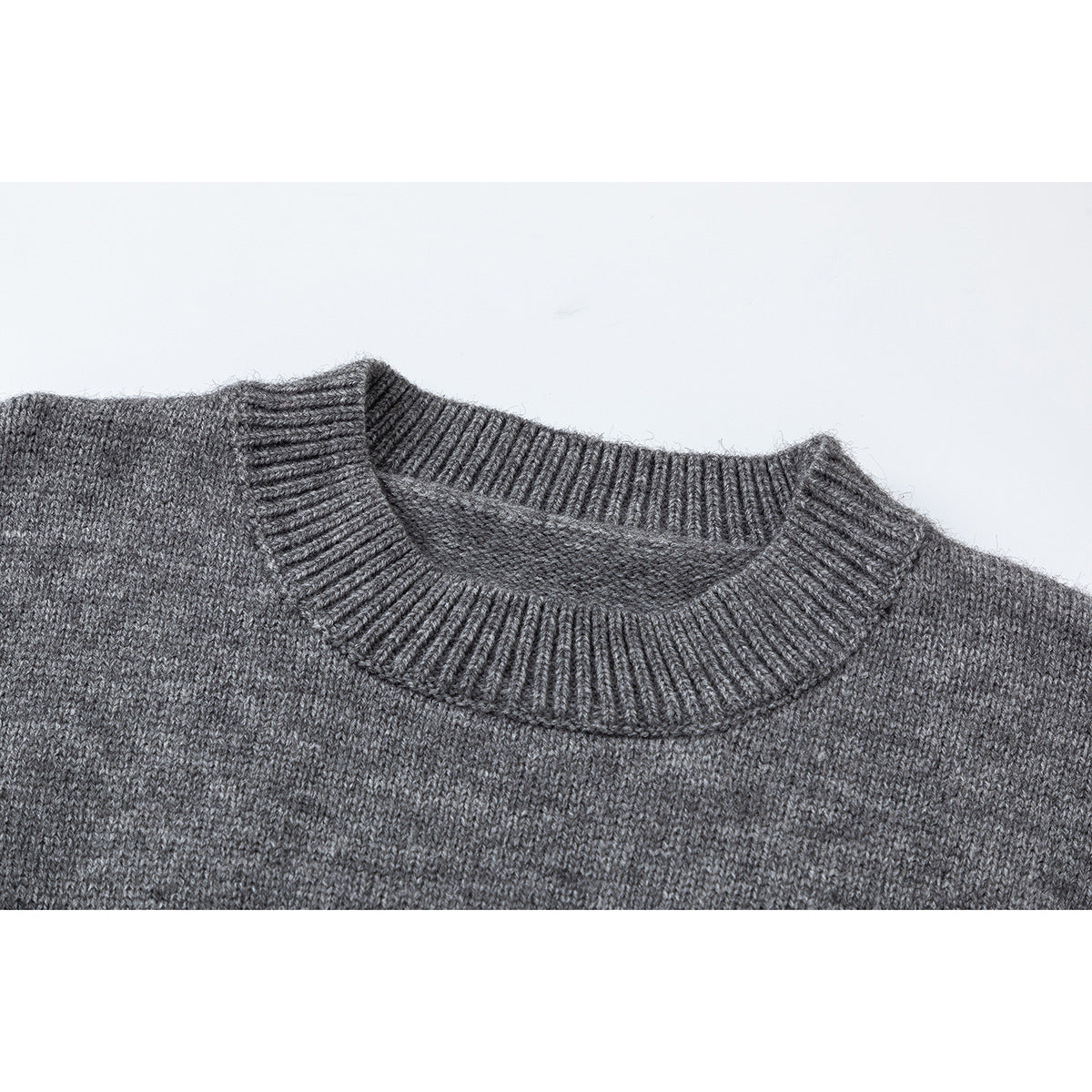 Close-up of the gray sweater's ribbed crew neckline and knit texture.