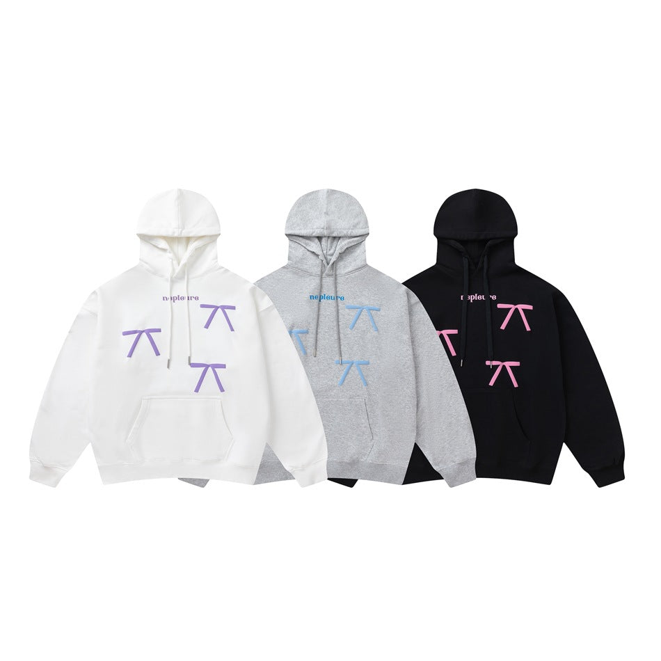 Three front-view pullover hoodies in white with purple graphics, gray with blue graphics, and black with pink graphics.