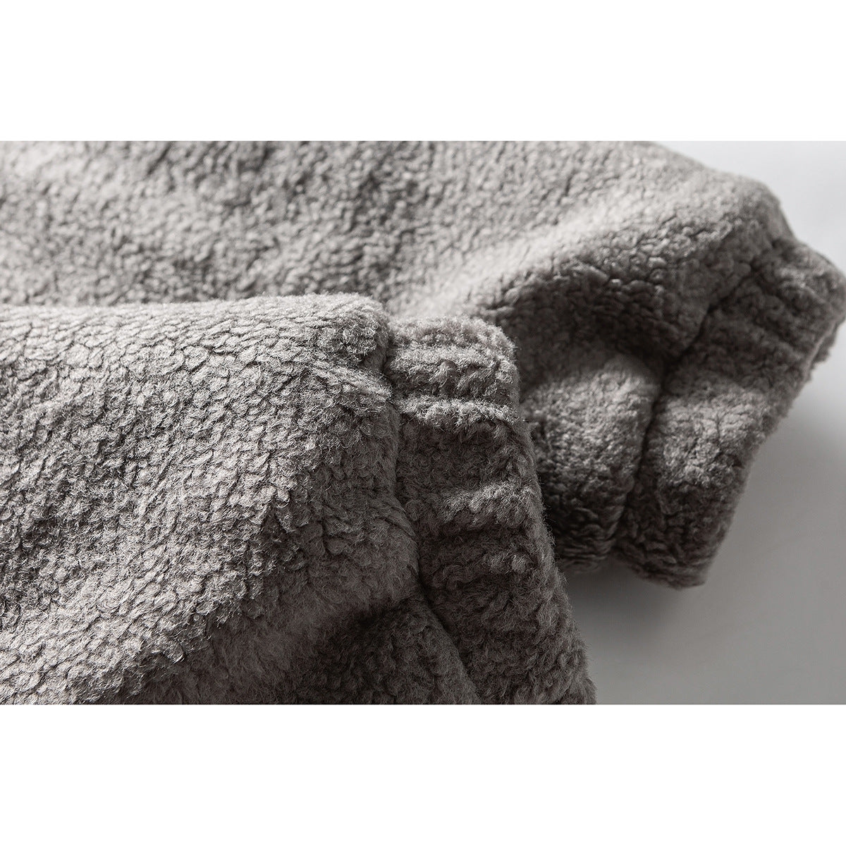 Close-up of the gray jacket's textured sleeve and gathered cuff.
