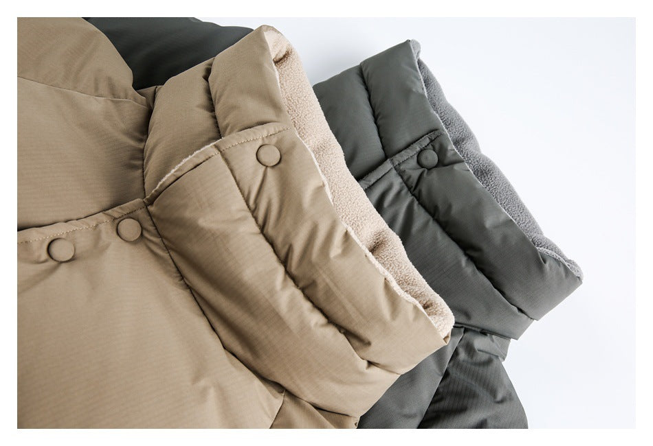 Close-up of beige and charcoal padded garments showing snap-fastened flaps and soft fleece-like lining.