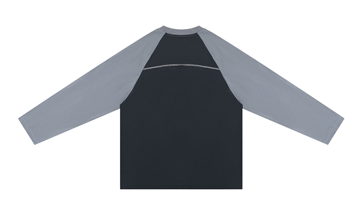Back of a charcoal long-sleeve raglan shirt with gray sleeves and a horizontal seam across the upper back.