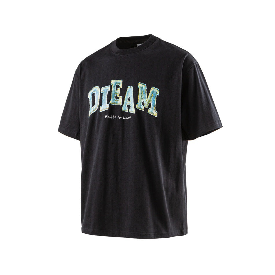 Black short-sleeve crew-neck T-shirt with blue-green arched DIEAM graphic and Built to Last script, angled view