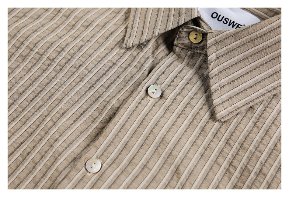 Close-up of the taupe striped shirt's collar, front buttons, and striped fabric.