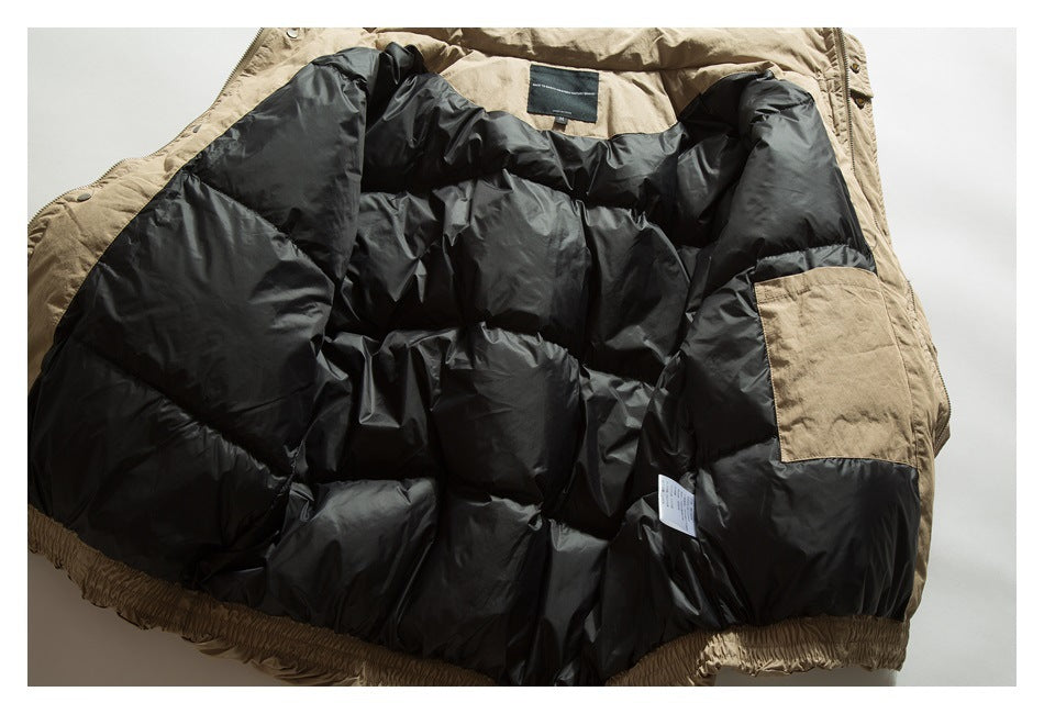 The tan jacket is opened flat to show its black padded interior lining and inner pocket.