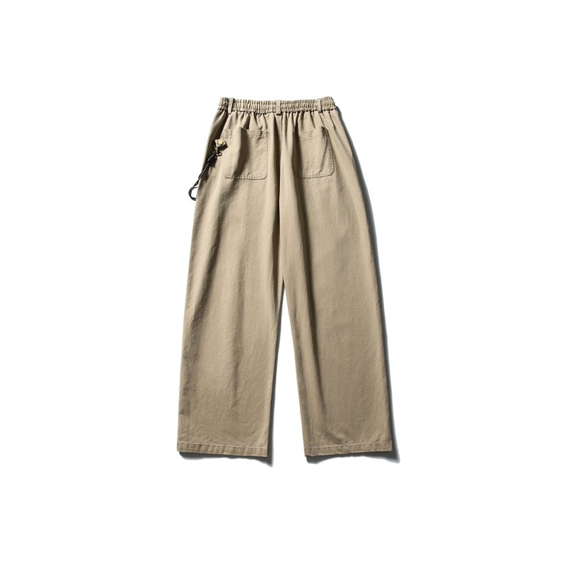 Back view of beige wide-leg trousers with an elastic waist, two patch pockets, and a side cord clip.