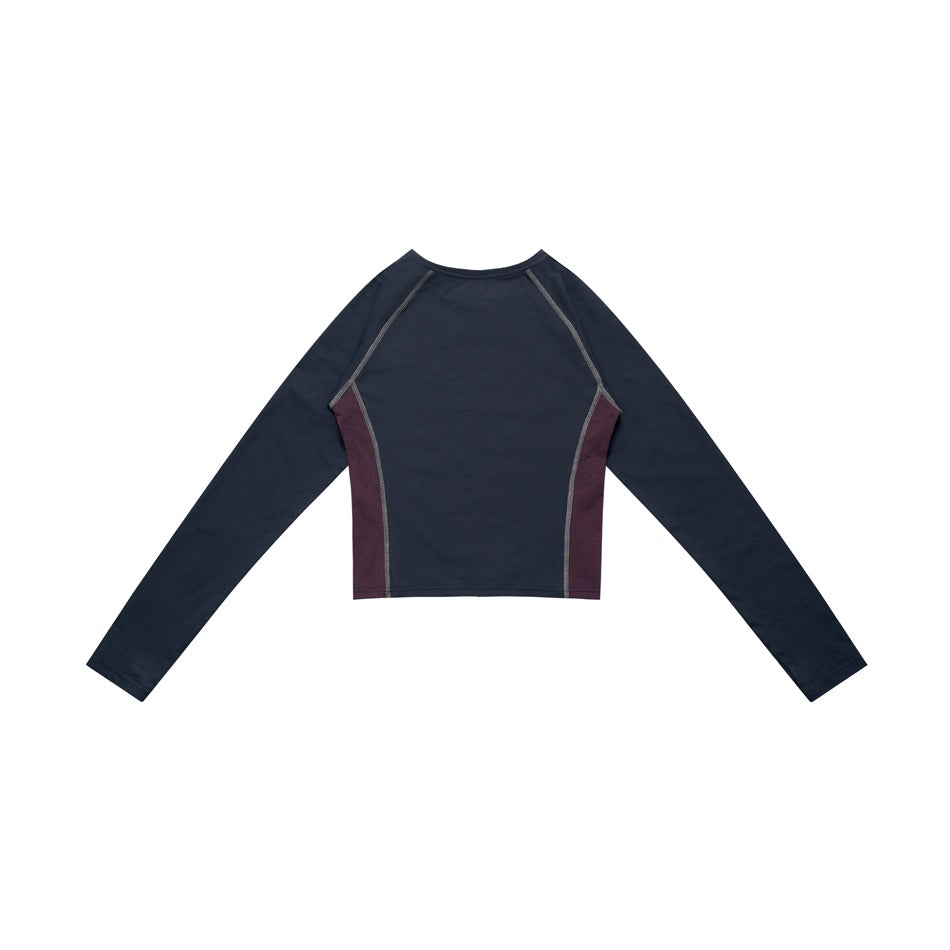 Back view of a navy long-sleeve cropped top with burgundy side panels and contrast seam lines.