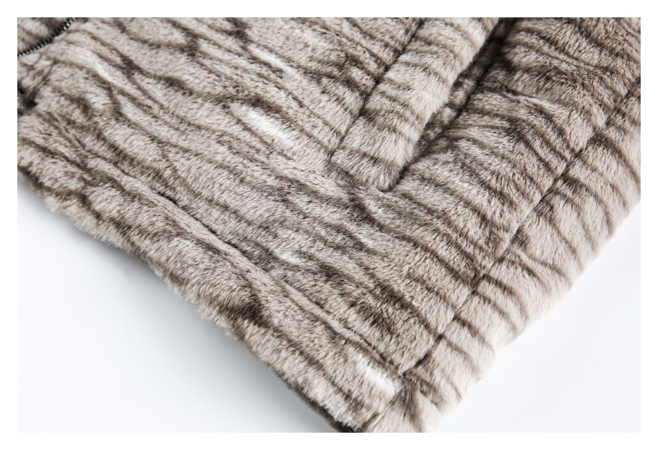 Close-up of a stitched lower edge on a gray-brown striped fur garment.