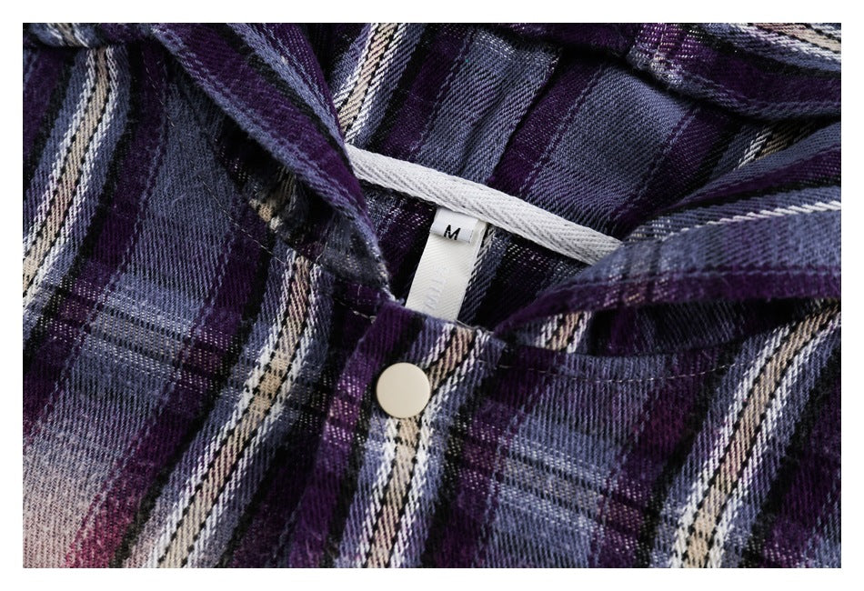 Close-up of the purple plaid shirt's neckline, snap button, and inner size label marked M.
