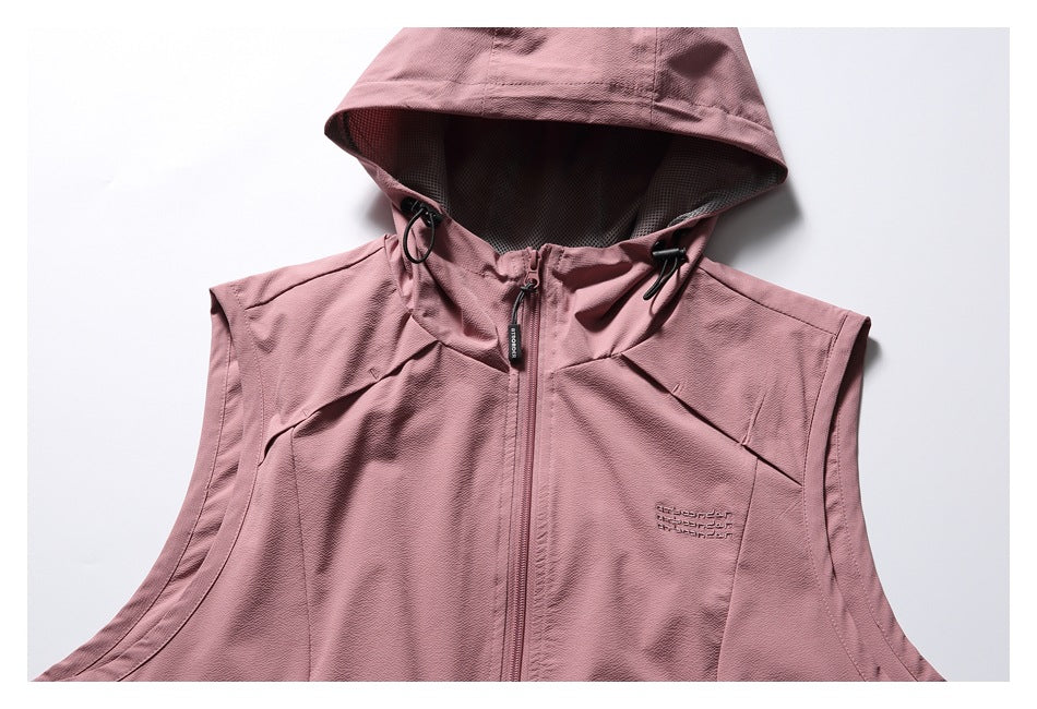Front close-up of a dusty rose sleeveless vest with a hood, black drawcord toggles, center zipper and chest embroidery.