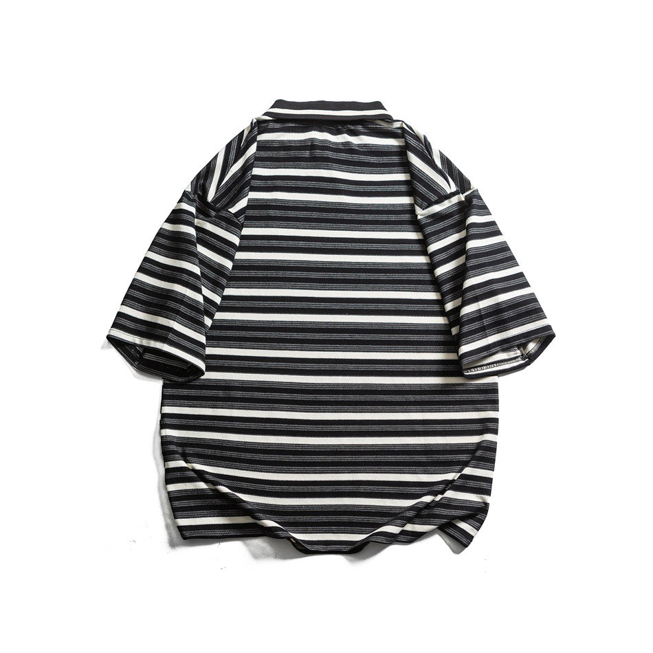 Back view of a black and white striped oversized collared T-shirt laid flat on a white background.