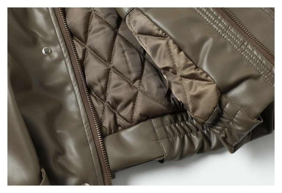 Close-up of the jacket's brown diamond-quilted lining, zipper, and gathered elastic waist detail.