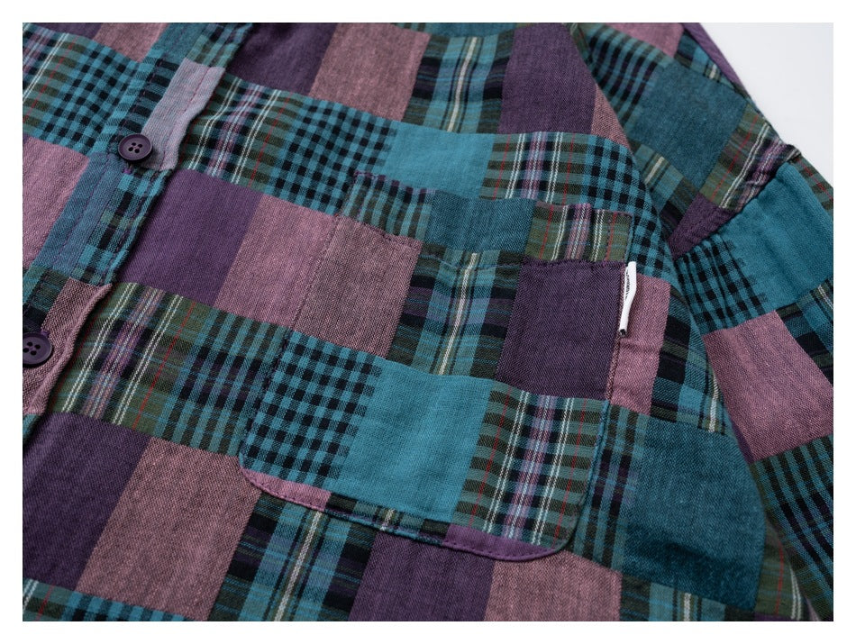 Close-up of a teal, purple, and dusty-pink patchwork plaid shirt with a button placket and chest pocket.