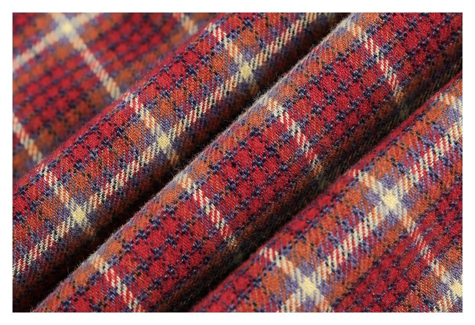 Macro view of the fuzzy woven texture and plaid pattern in red, navy, and cream.