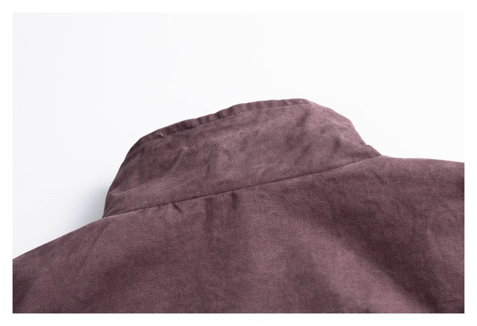 Close-up of the collar and upper back of a dusty mauve garment.