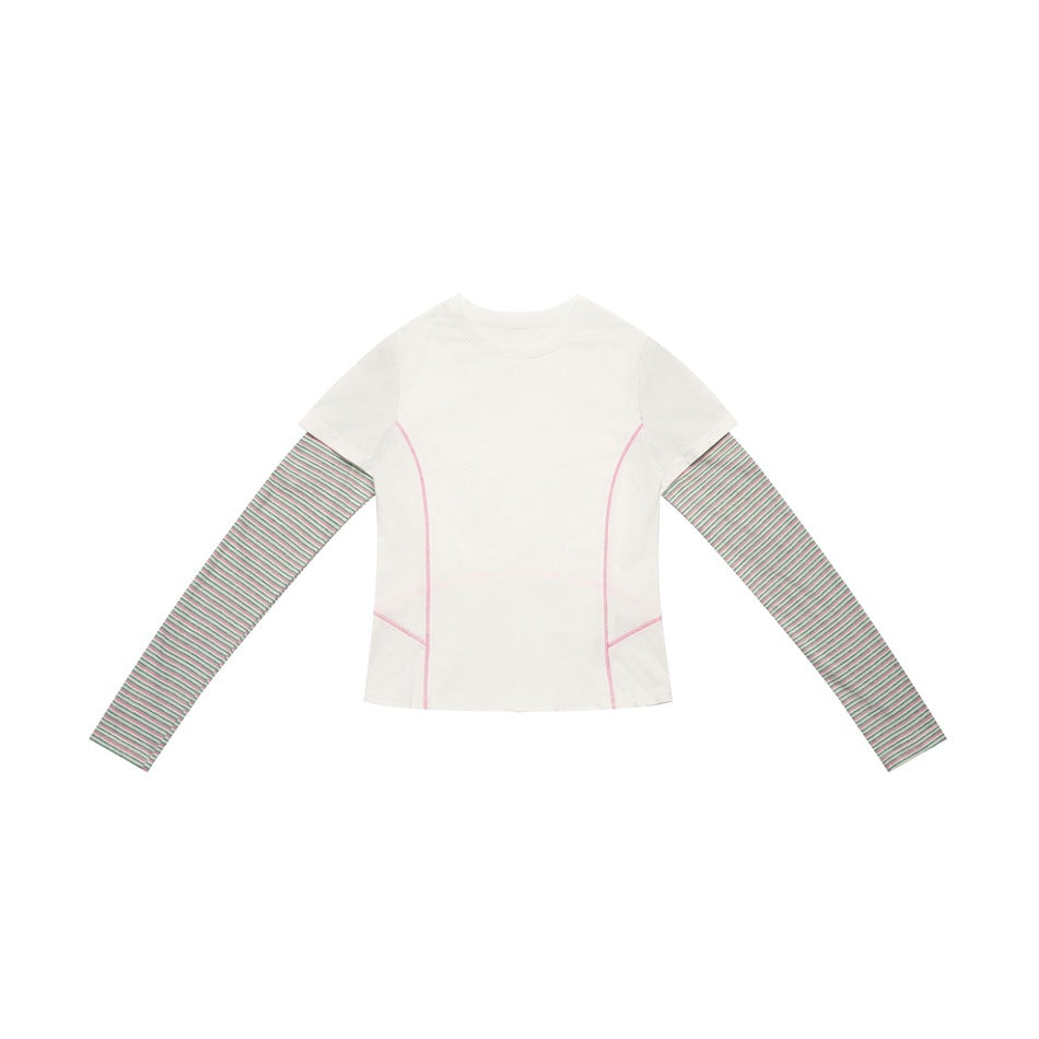 White layered-look top with pink contrast seam stitching and gray-green striped long sleeves, flat lay