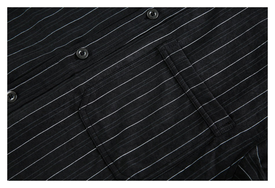 Close-up of a black pinstriped shirt's button placket and chest pocket.