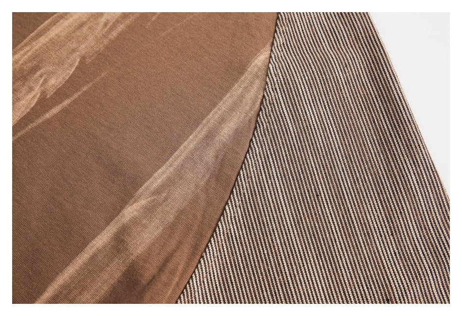 Close-up showing brown fabric with pale streaks beside a black-and-cream patterned panel.