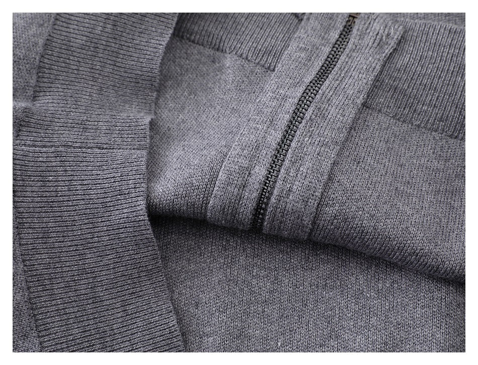 Close-up of the gray cardigan folded to show its ribbed trim and zipper.
