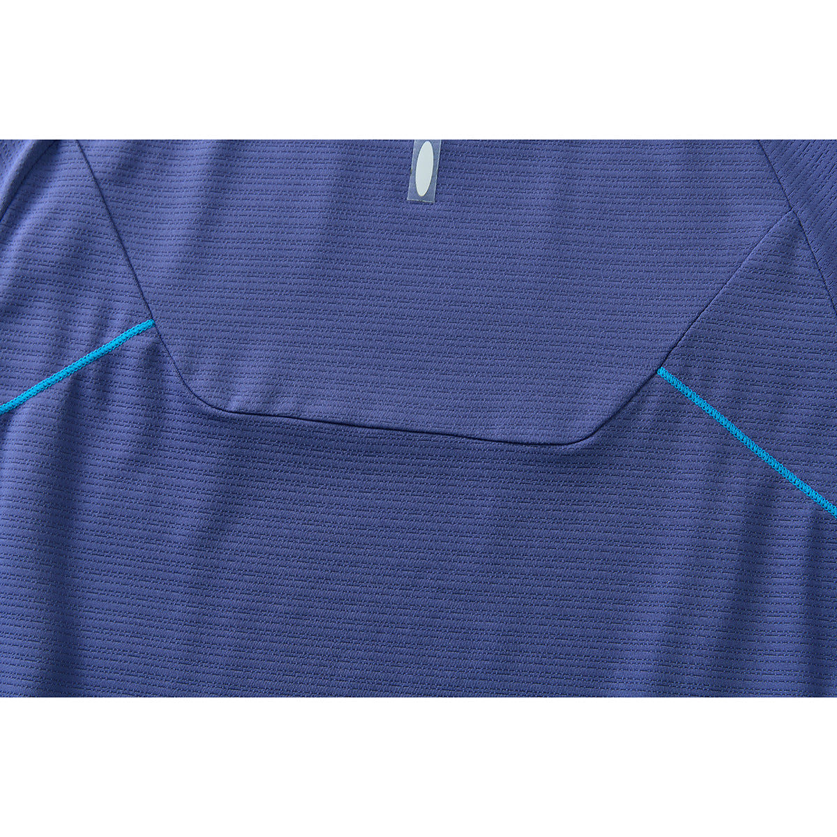 Close-up of the blue shirt's back panel with curved seams, turquoise stitching, and a small reflective tab.