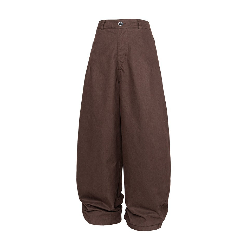 Brown wide-leg curved trousers with button waistband and belt loops, front view on white background