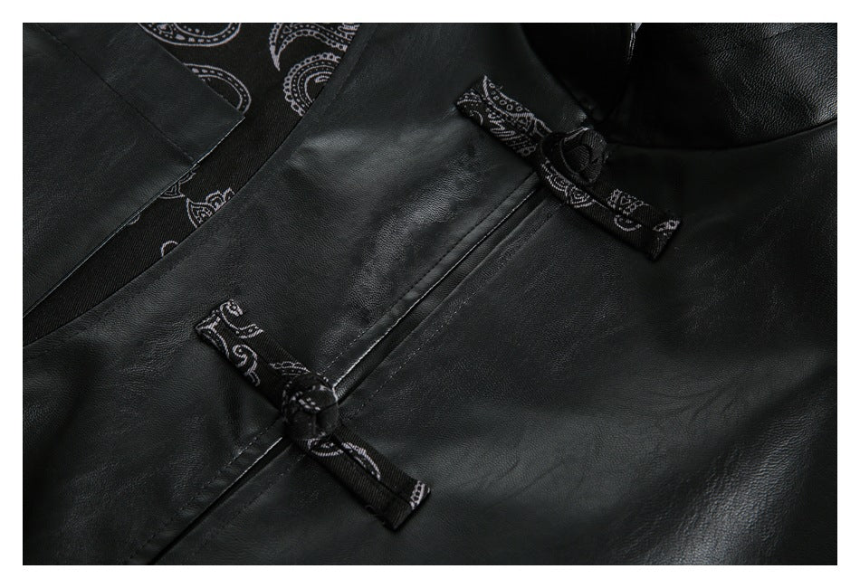 Close-up of a black jacket with paisley-print fabric trim and knotted toggle closures.