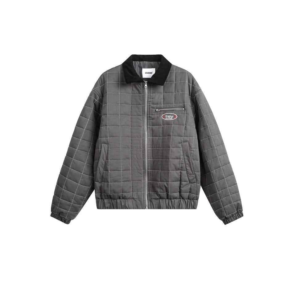 Dark gray quilted zip jacket with grid stitching, black collar, chest zip pocket and oval patch, flat front view