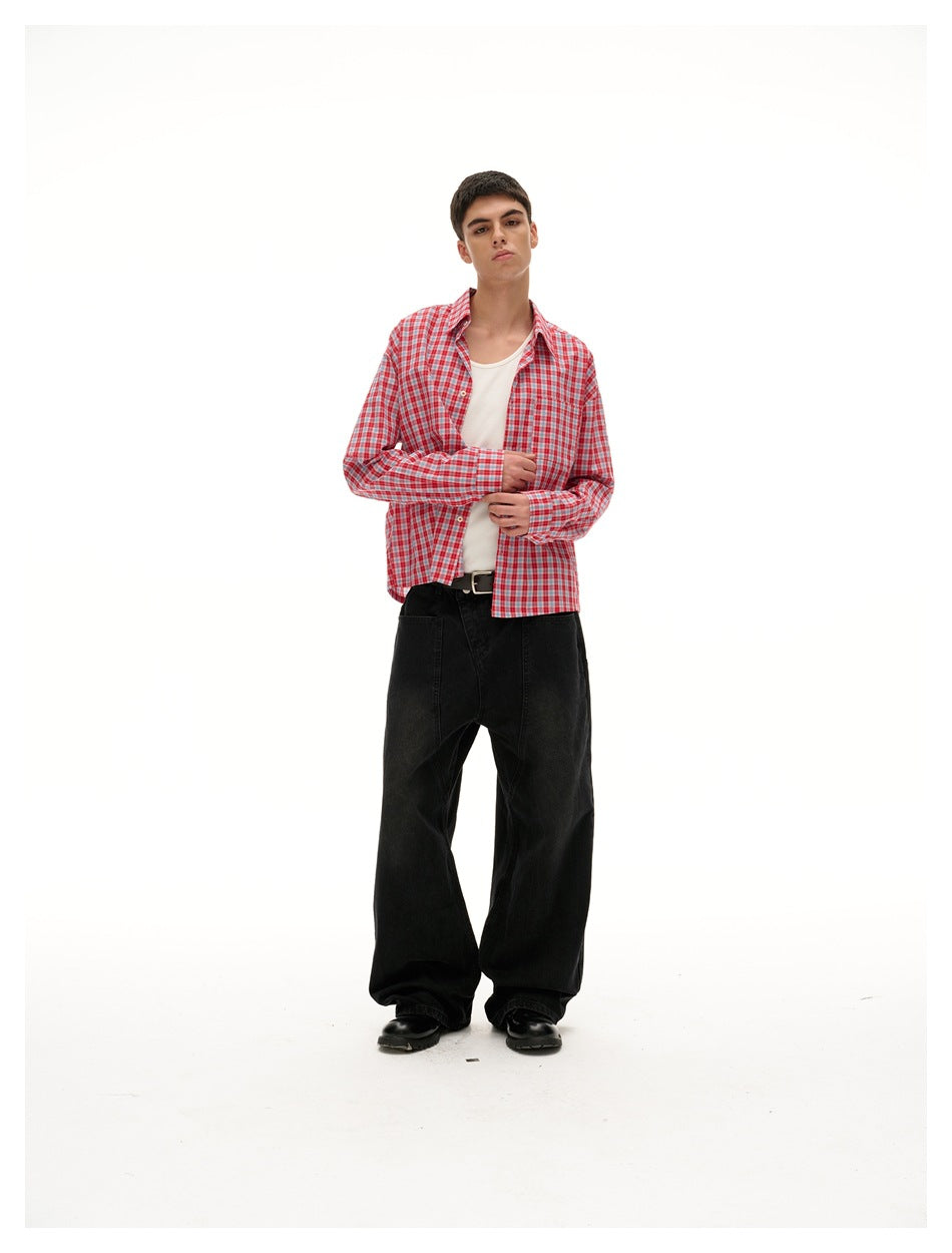 Full-length model wearing an open red-and-white plaid shirt over a white top with black wide-leg trousers.