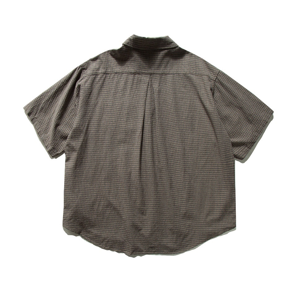 Back view of brown micro-check short-sleeve shirt showing yoke and center back pleat