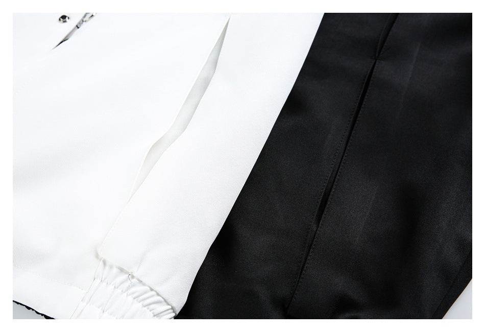 Close-up of white and black garment panels, showing seams and a gathered white edge.