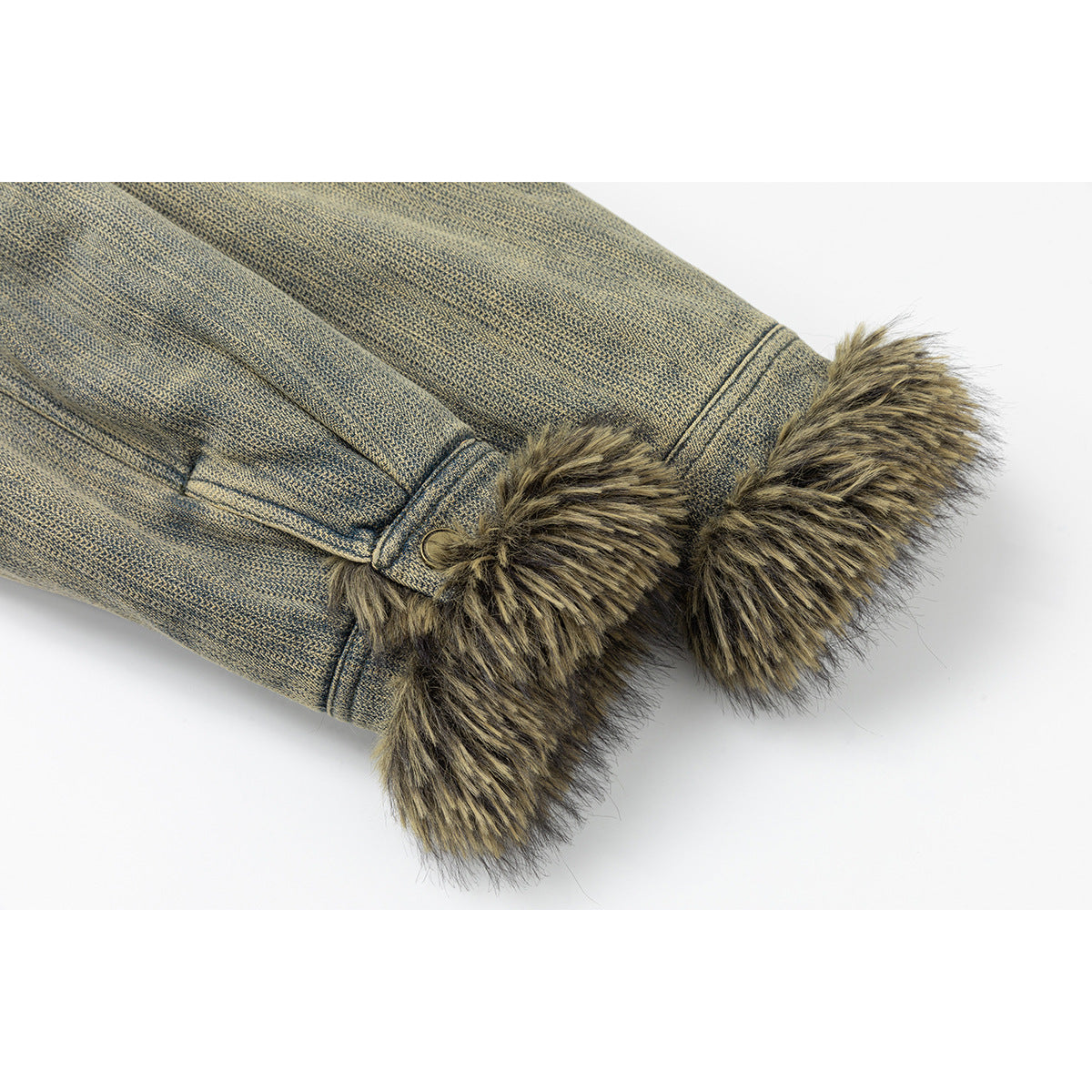Close-up of a blue-gray jacket sleeve ending in a thick brown and black fur-trimmed cuff.