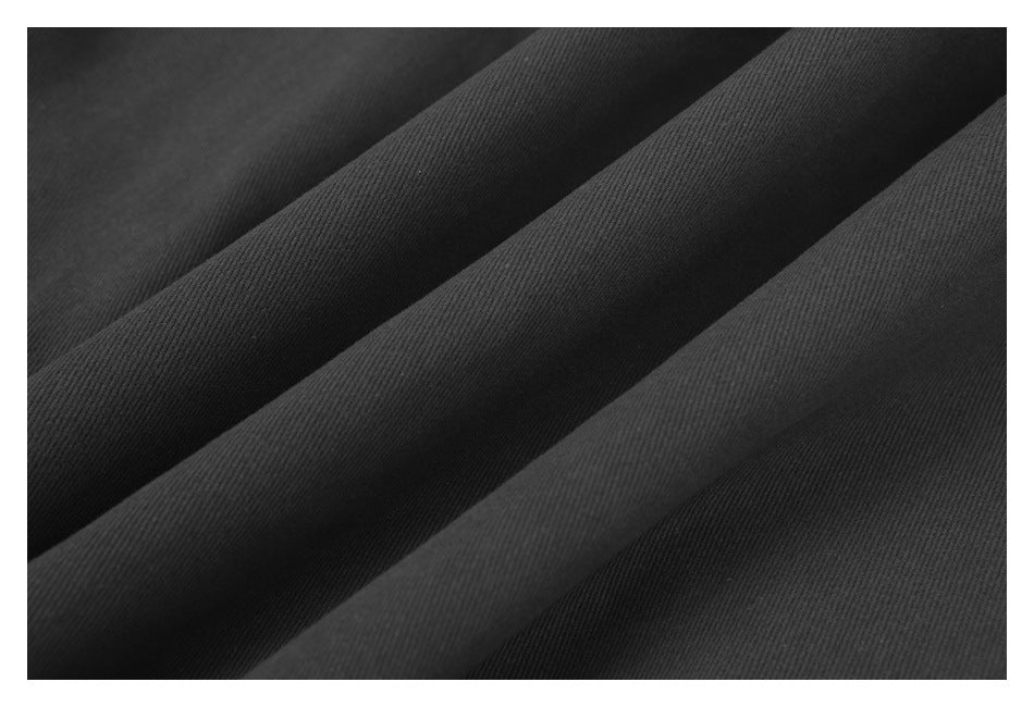 Macro view of the dark charcoal jacket fabric showing its fine diagonal weave.