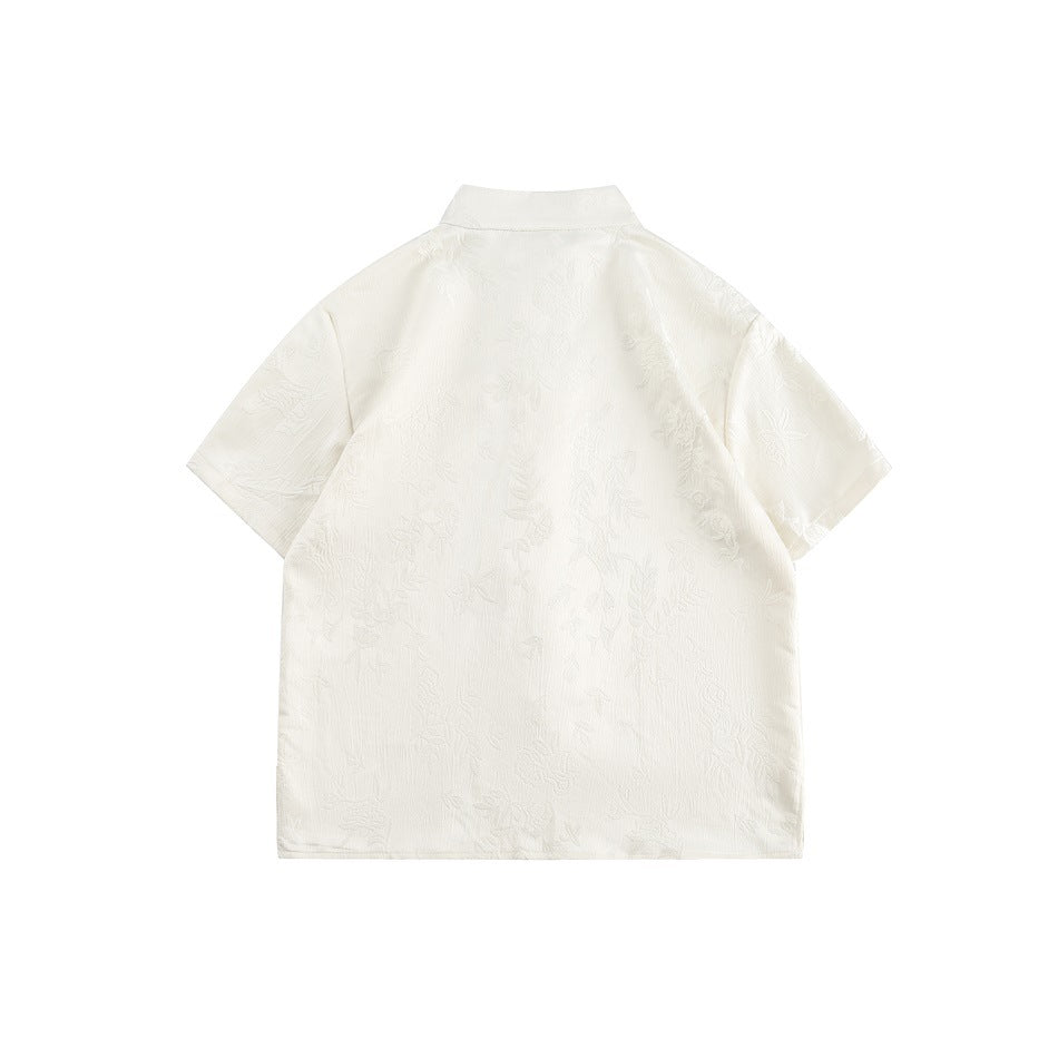 Back view of an ivory short-sleeve mandarin-collar shirt with subtle floral patterning.