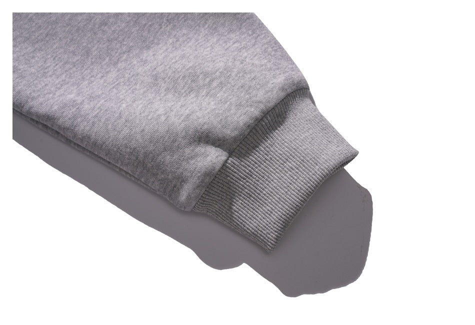 Close-up of a heather-gray sleeve ending in a wide rib-knit cuff.