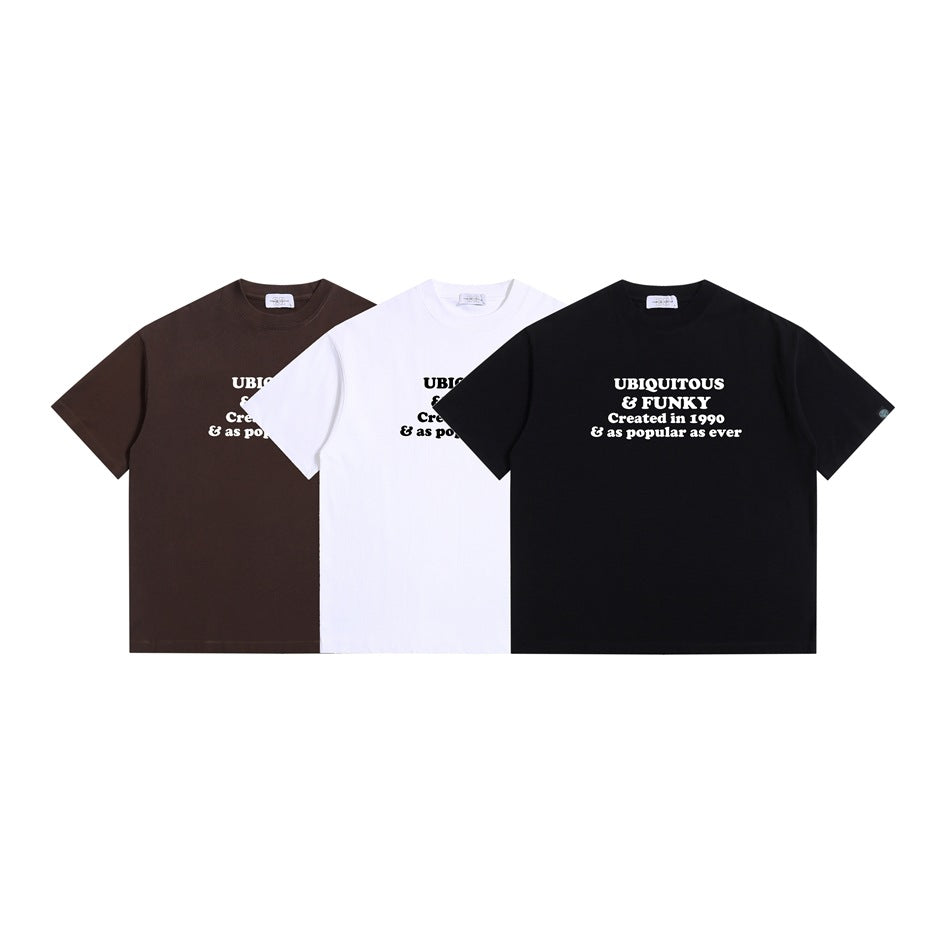 Front view of three short-sleeve graphic T-shirts in dark brown, white, and black.