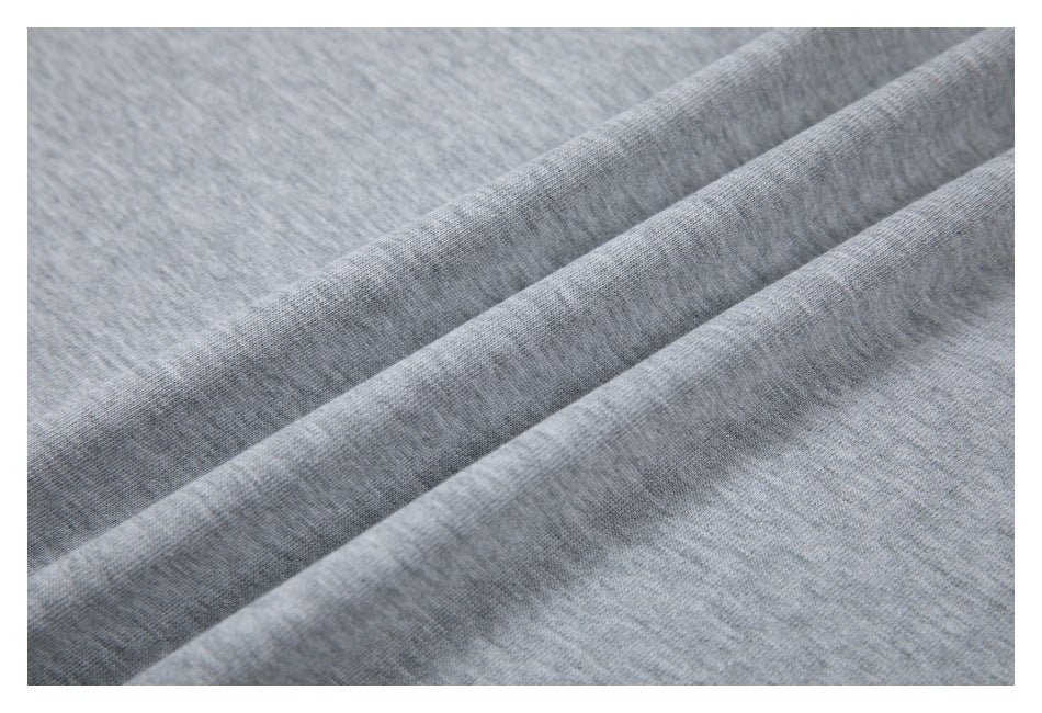 Close-up of gray knit fabric arranged in soft folds.