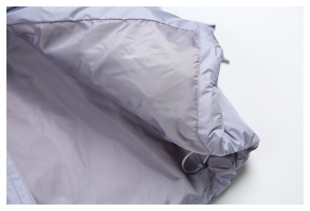 Close-up of the light lavender-gray garment's smooth inner lining and stitched edge.