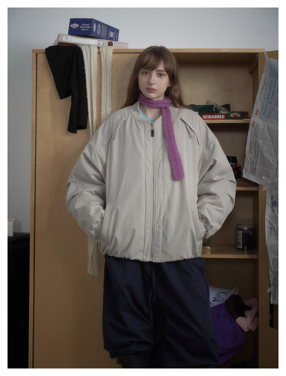 Model wearing a light gray zip-front bomber jacket with oversized sleeves, elastic cuffs and hem, shown from the front.
