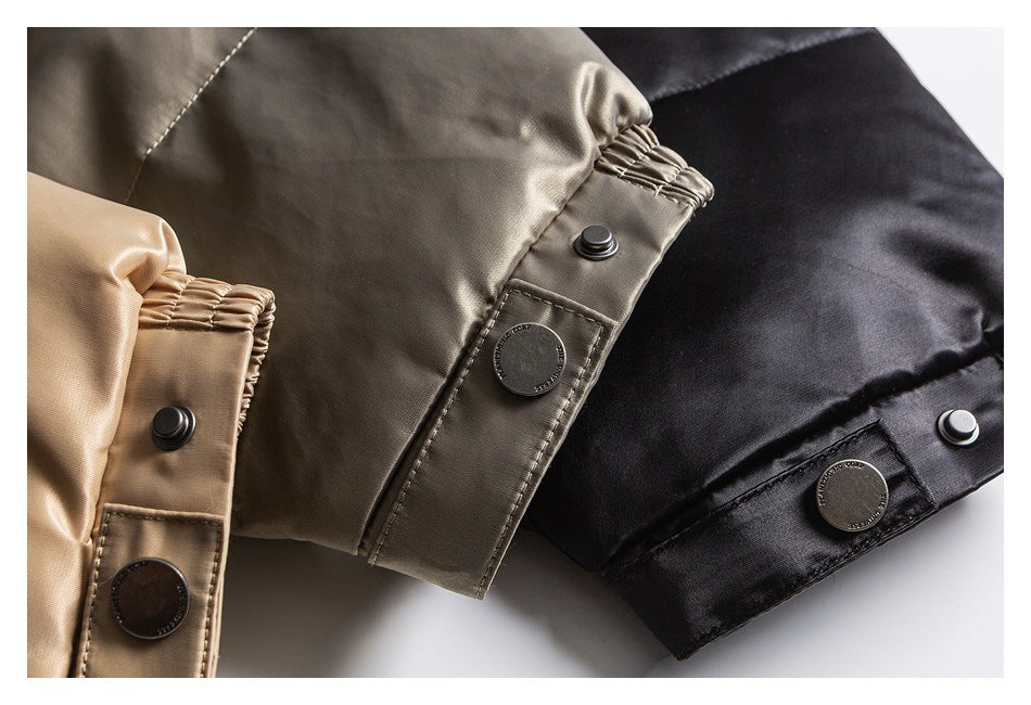Close-up of beige, taupe, and black jacket cuffs with gathered elastic and snap-button tabs.