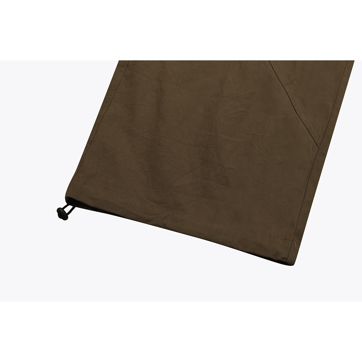 Close-up of an olive-brown pant leg hem with a black adjustable drawcord toggle.