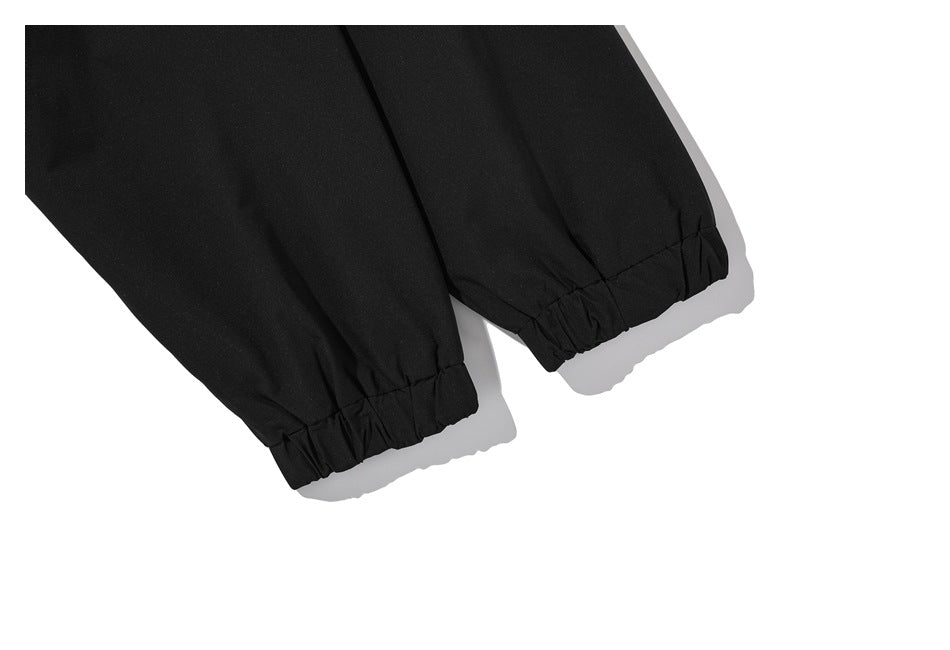 Close-up of two black jacket sleeves with gathered elastic cuffs.