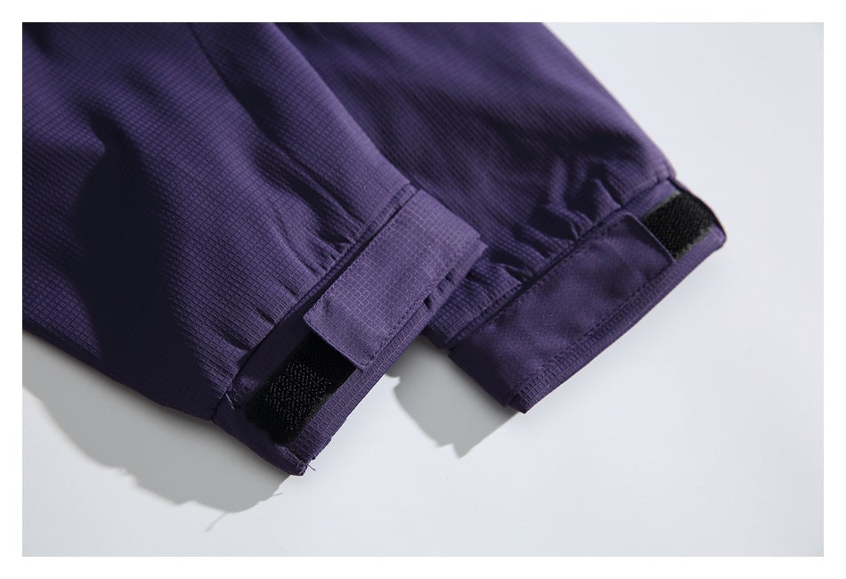 Close-up of purple jacket cuffs with adjustable hook-and-loop tabs.